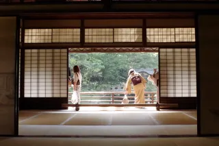 An AI agent on one side of a shoji screen, the eval suite walled off on the other.